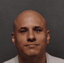 Close-up of a man with a serious expression, representing community safety efforts in San Antonio.