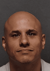 Close-up of a man with a serious expression, representing community safety efforts in San Antonio.
