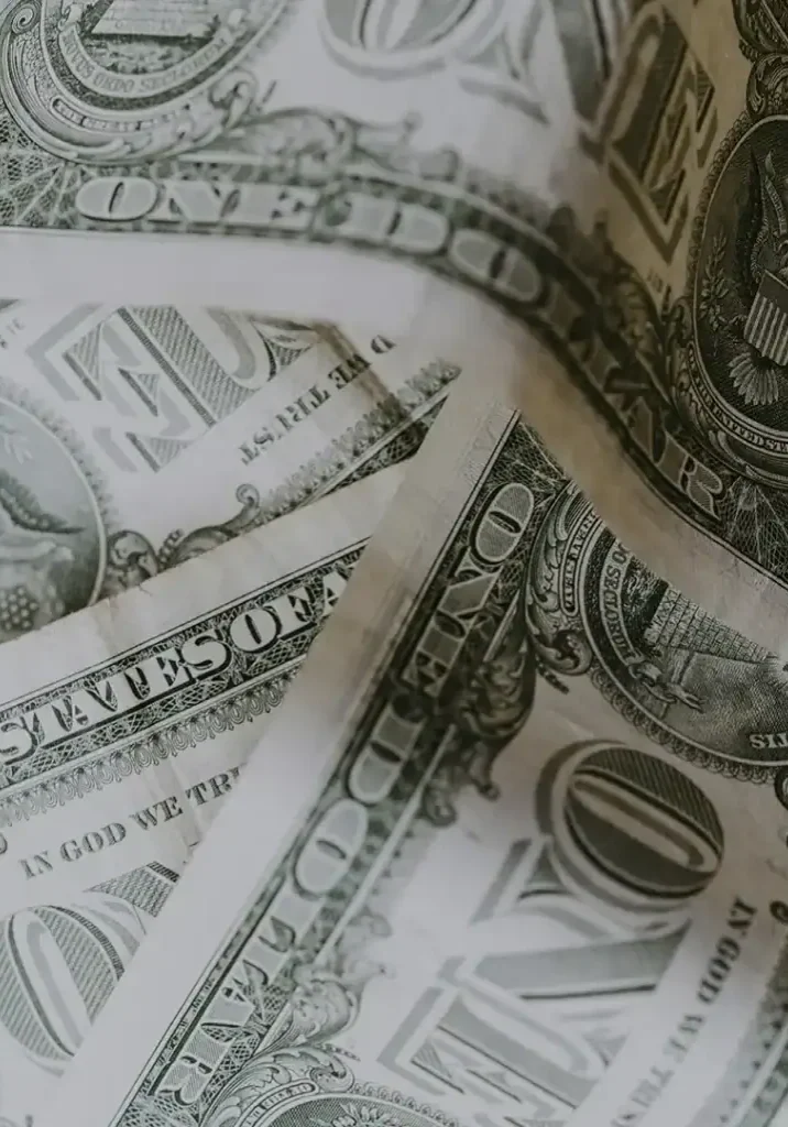 Close-up of US dollar bills emphasizing crime prevention funding in San Antonio.