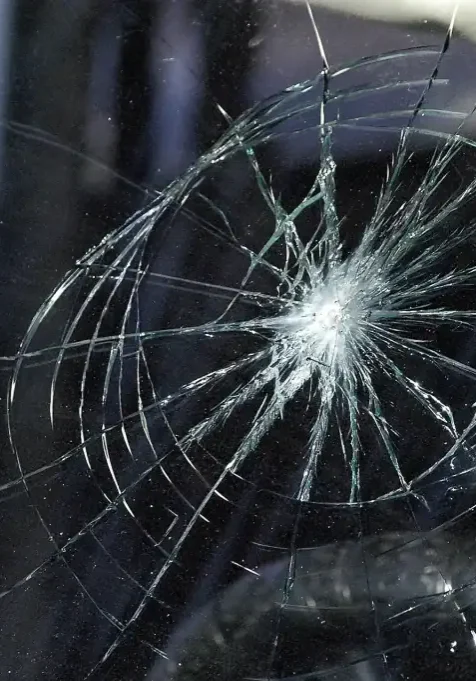 Cracked windshield with shattered glass in San Antonio crime scene investigation.